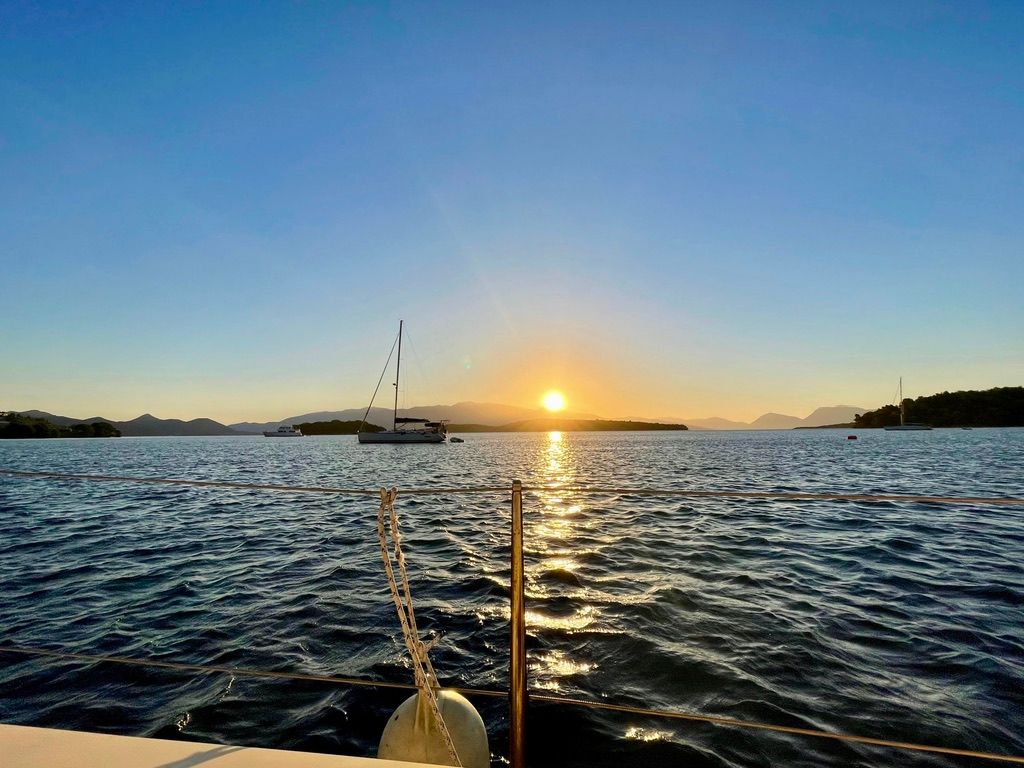 Sunrise view from a sailboat on the ocean in Nydri, Lefkada, Greece. 