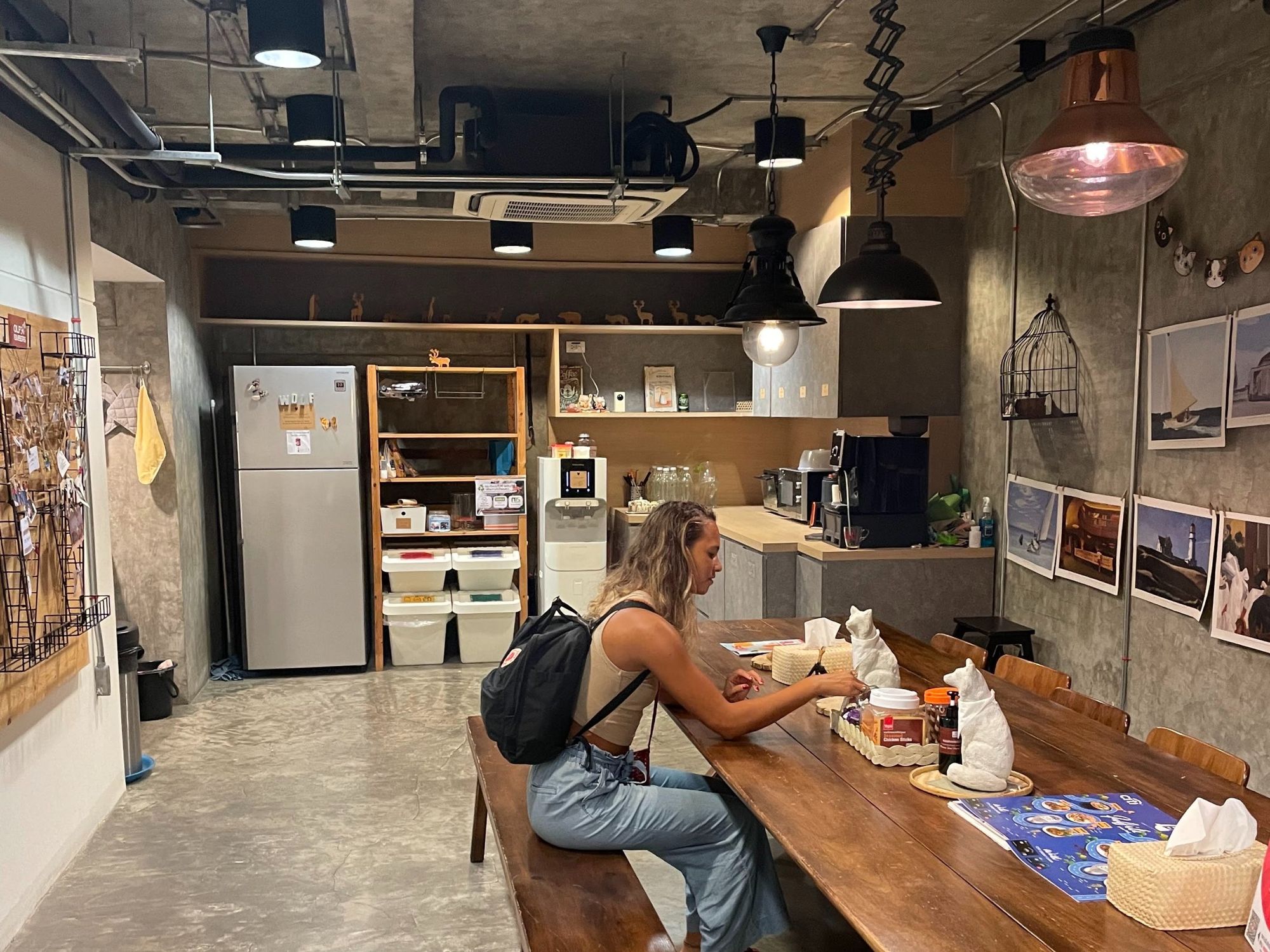 First floor of Wolf coworking space, Bangkok, Thailand. The reception area opens up into a large communal table connected to a kitchen where you can access all the essentials you’d expect.