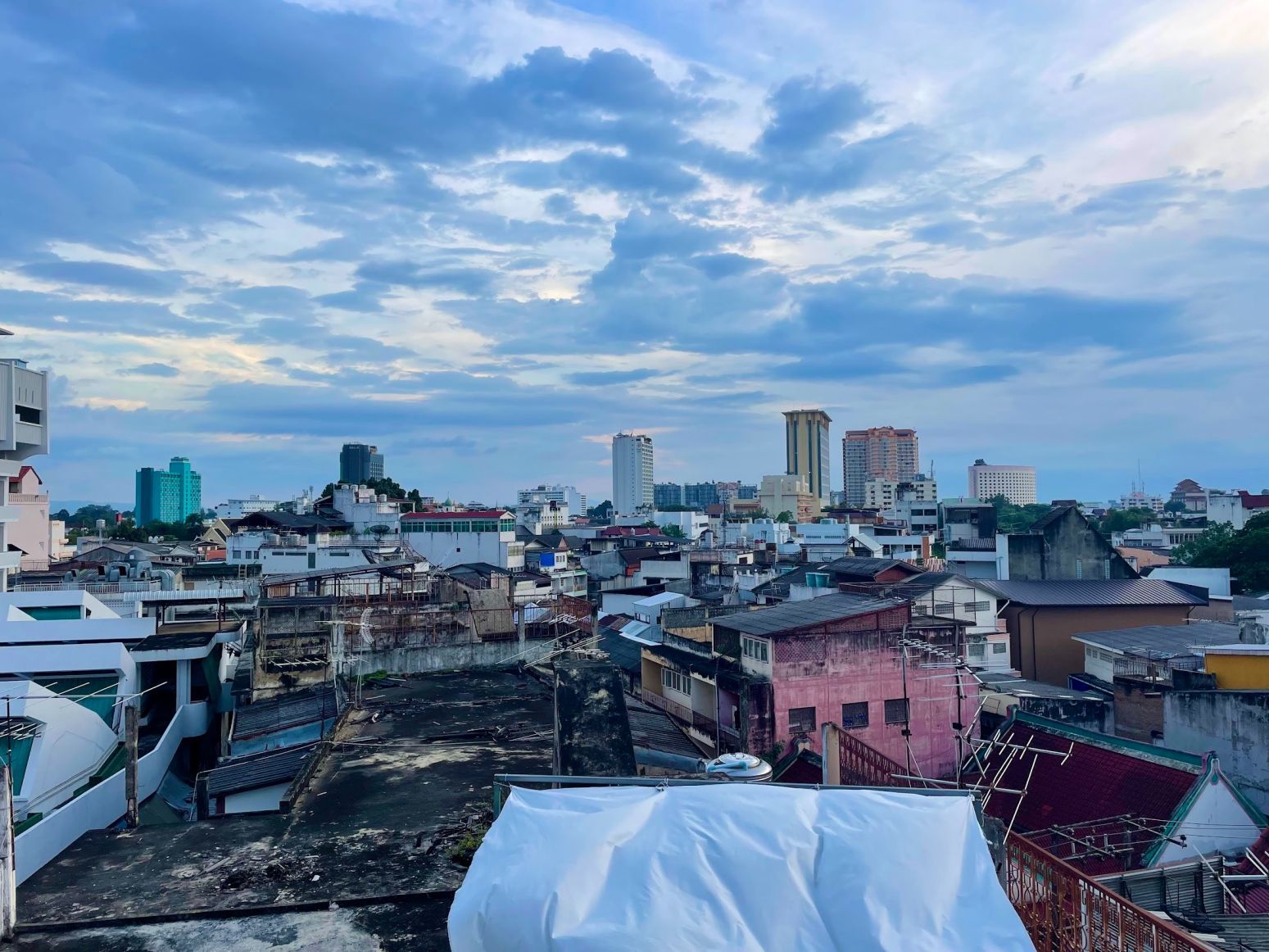 Chiang Mai from above, rooftops, blue sky with clouds