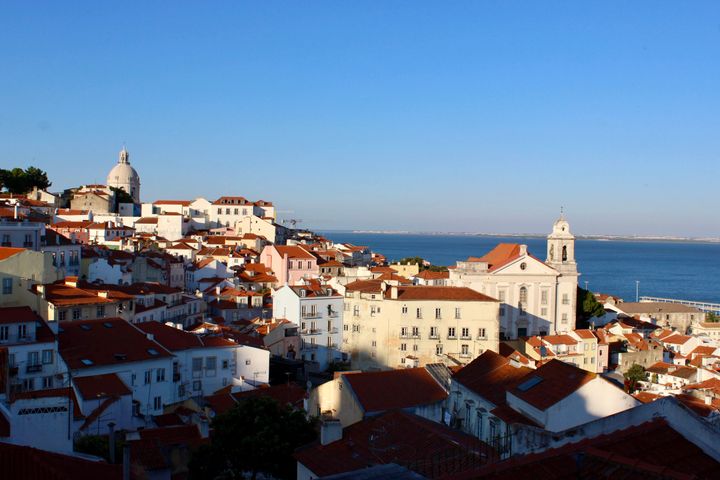 Birdseye view of the city Lisbon, Portugal, white houses with red rooftops, church, ocean